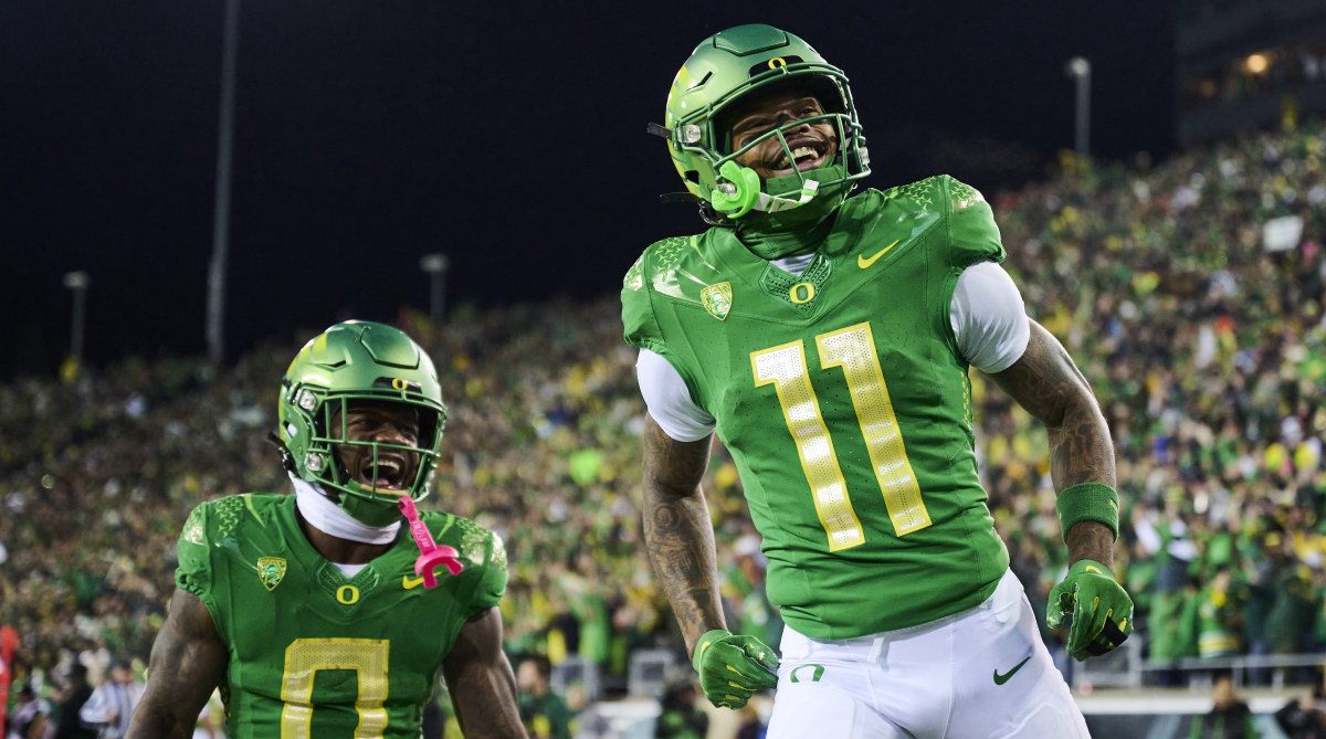Oregon wide receiver Troy Franklin, right, celebrates after scoring a touchdown