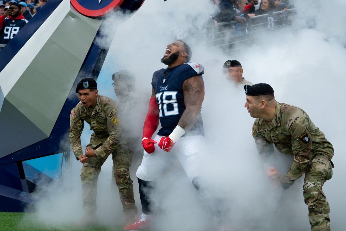 Tennessee Titans defensive tackle Jeffery Simmons (98) makes his entrance with service members from Fort Campbell.