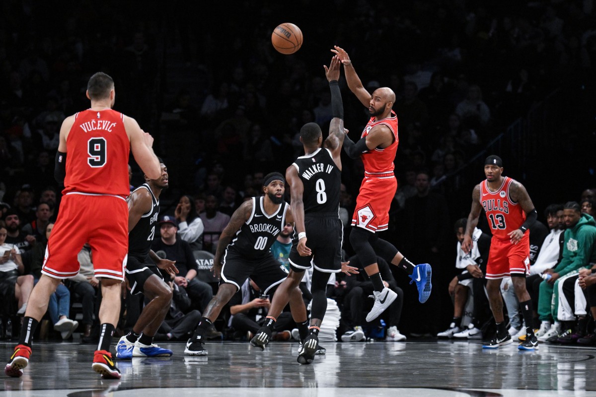 Chicago Bulls guard Jevon Carter (5) passes the ball to Chicago Bulls center Nikola Vucevic (9) as Brooklyn Nets forward Royce O'Neale (00) and Brooklyn Nets guard Lonnie Walker IV (8) defend during the second quarter at Barclays Center.