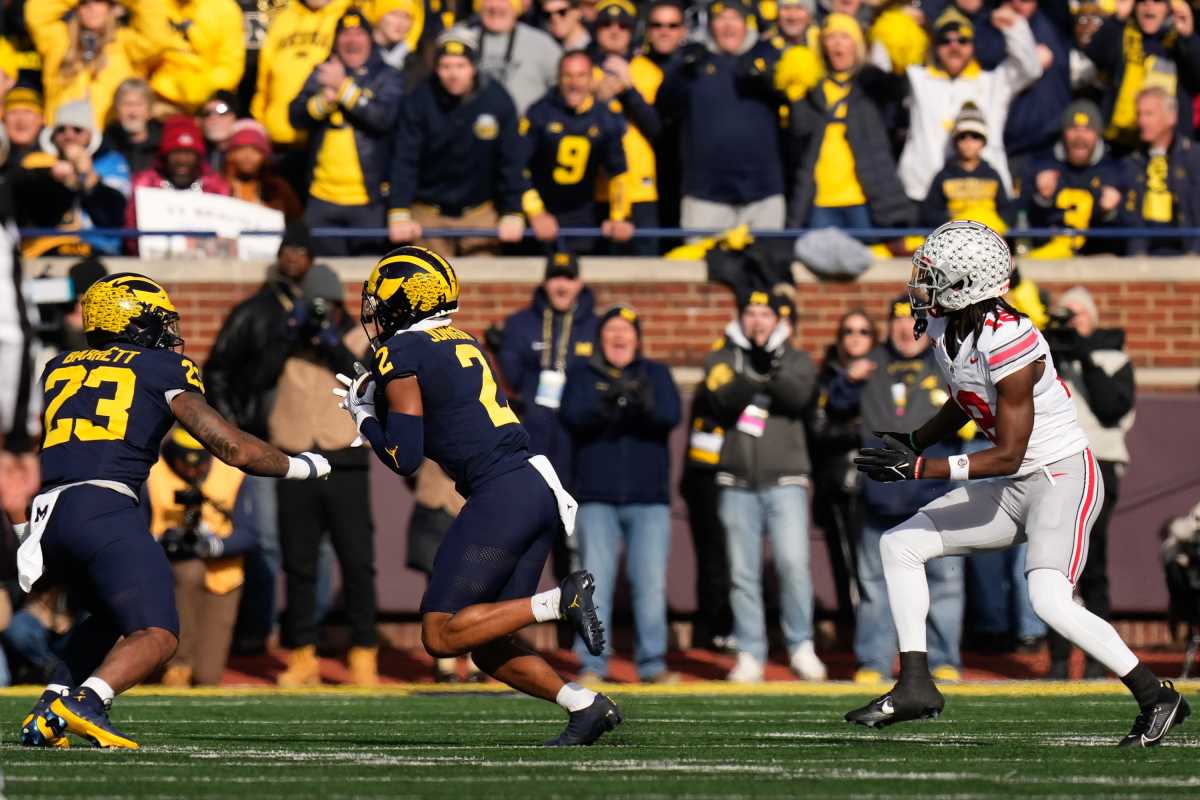 Nov 25, 2023; Ann Arbor, Michigan, USA; Michigan Wolverines defensive back Will Johnson (2) intercepts a pass intended for Ohio State Buckeyes wide receiver Marvin Harrison Jr. (18) during the NCAA football game at Michigan Stadium. Ohio State lost 30-24. (Adam Cairns/Columbus Dispatch / USA TODAY NETWORK).