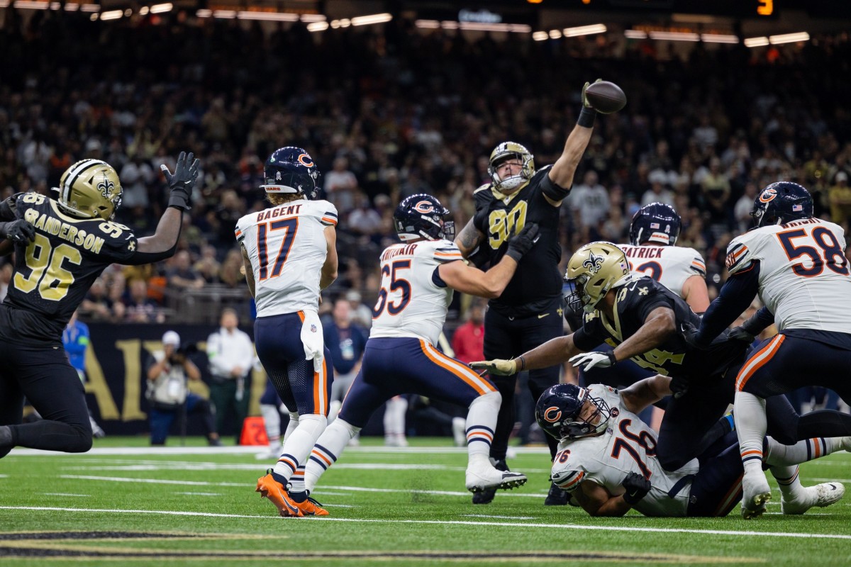 Chicago Bears quarterback Tyson Bagent (17) has his pass blocked by New Orleans Saints defensive tackle Bryan Bresee (90). Mandatory Credit: Stephen Lew-USA TODAY Sports