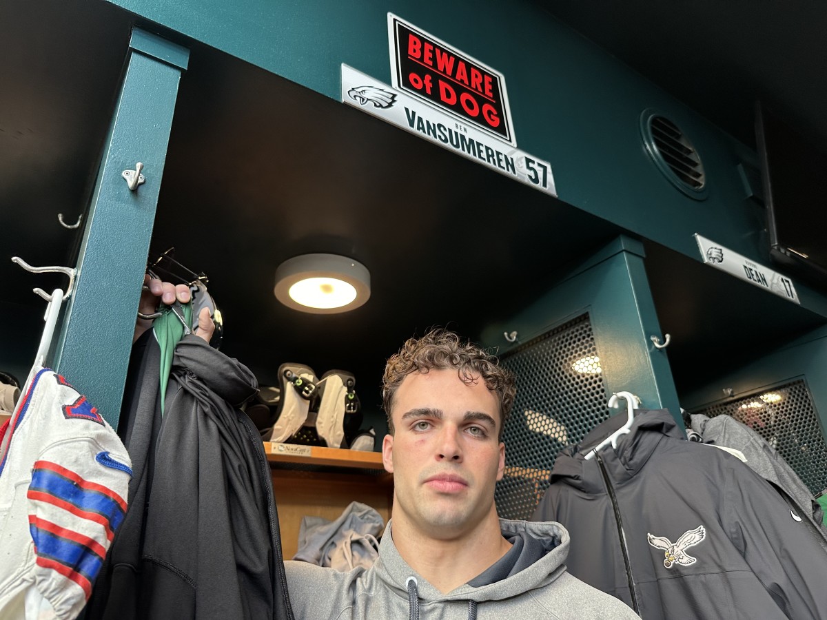 Ben VanSumeren beneath the sign that Cam Jurgens ordered for him because of the linebacker's sleepwalking habits