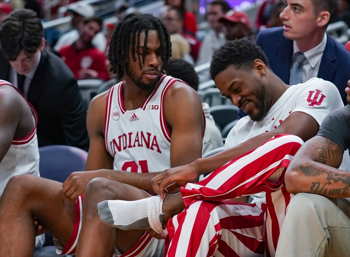 Indiana Hoosiers guard Xavier Johnson (0) looks at his ankle on the bench during the game against Harvard in Gainbridge Fieldhouse in Indianapolis, Ind. on Sunday, Nov. 26, 2023.