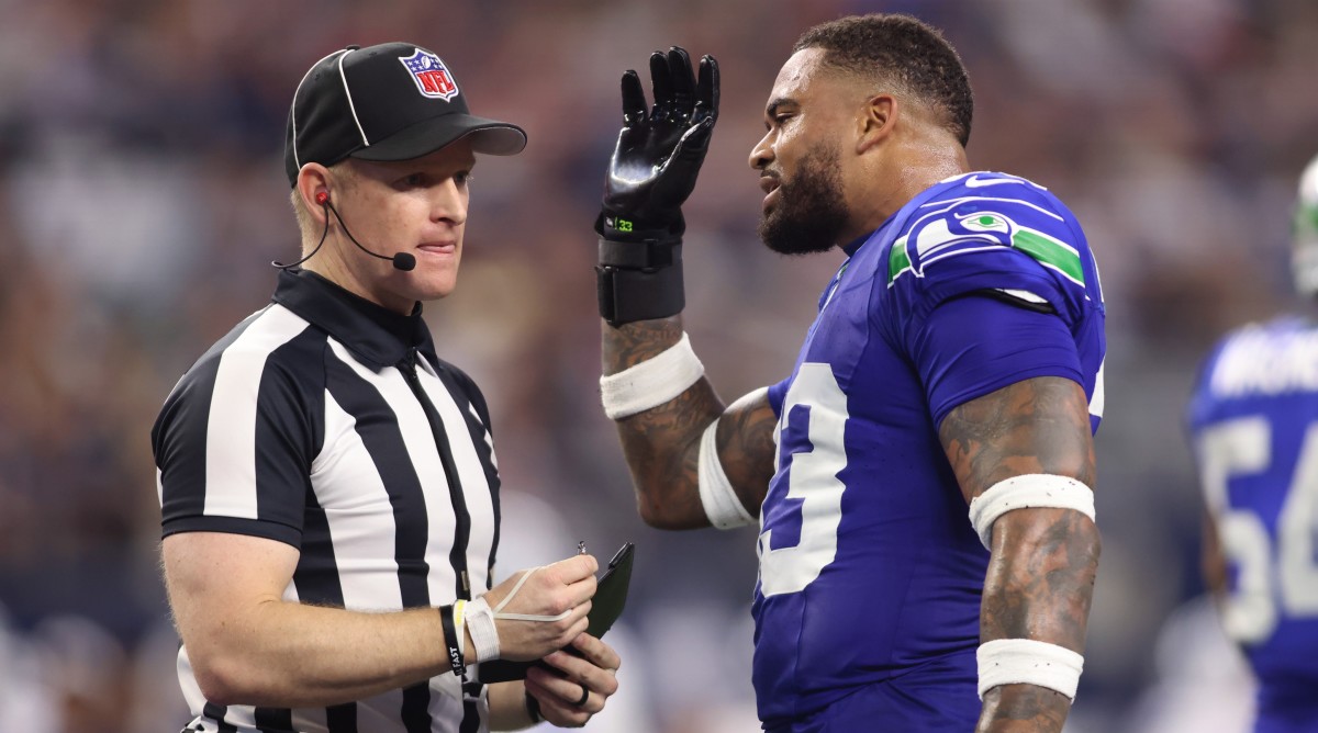 Seahawks safety Jamal Adams discusses a call with an official during a game against the Cowboys.