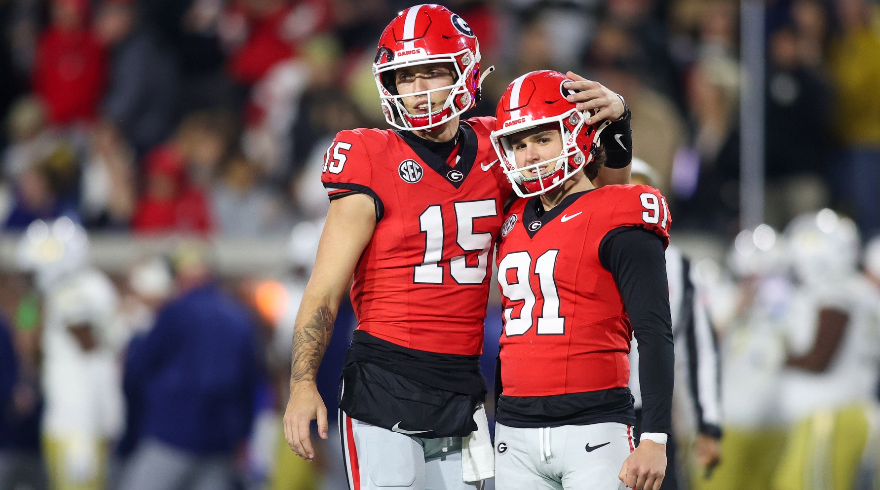 Georgia quarterback Carson Beck embraces kicker Peyton Woodring after a made extra point.