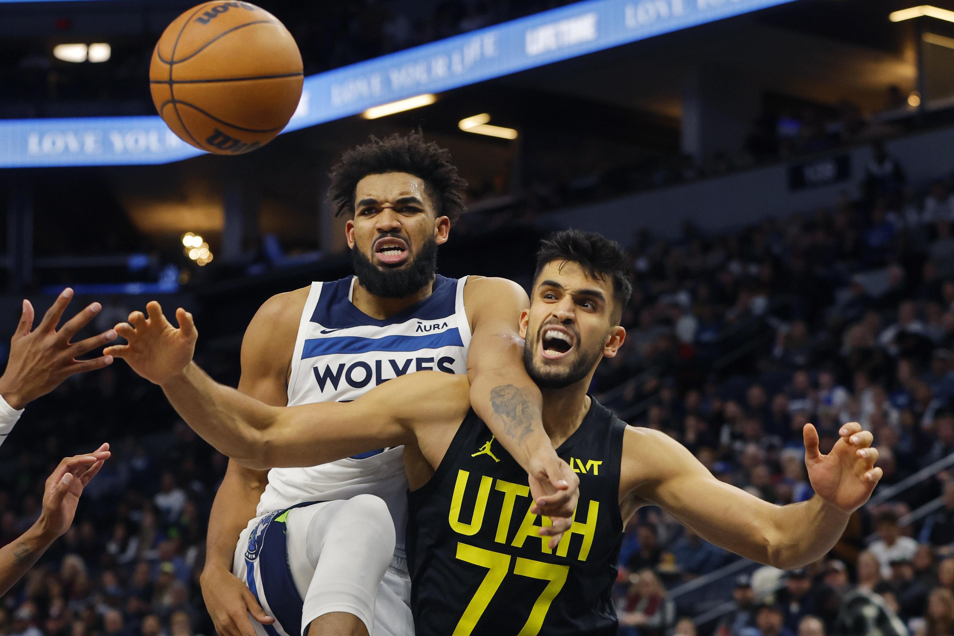 Nov 30, 2023; Minneapolis, Minnesota, USA; Minnesota Timberwolves forward Karl-Anthony Towns (32) and Utah Jazz center Omer Yurtseven (77) watch a loose ball go in the third quarter at Target Center.