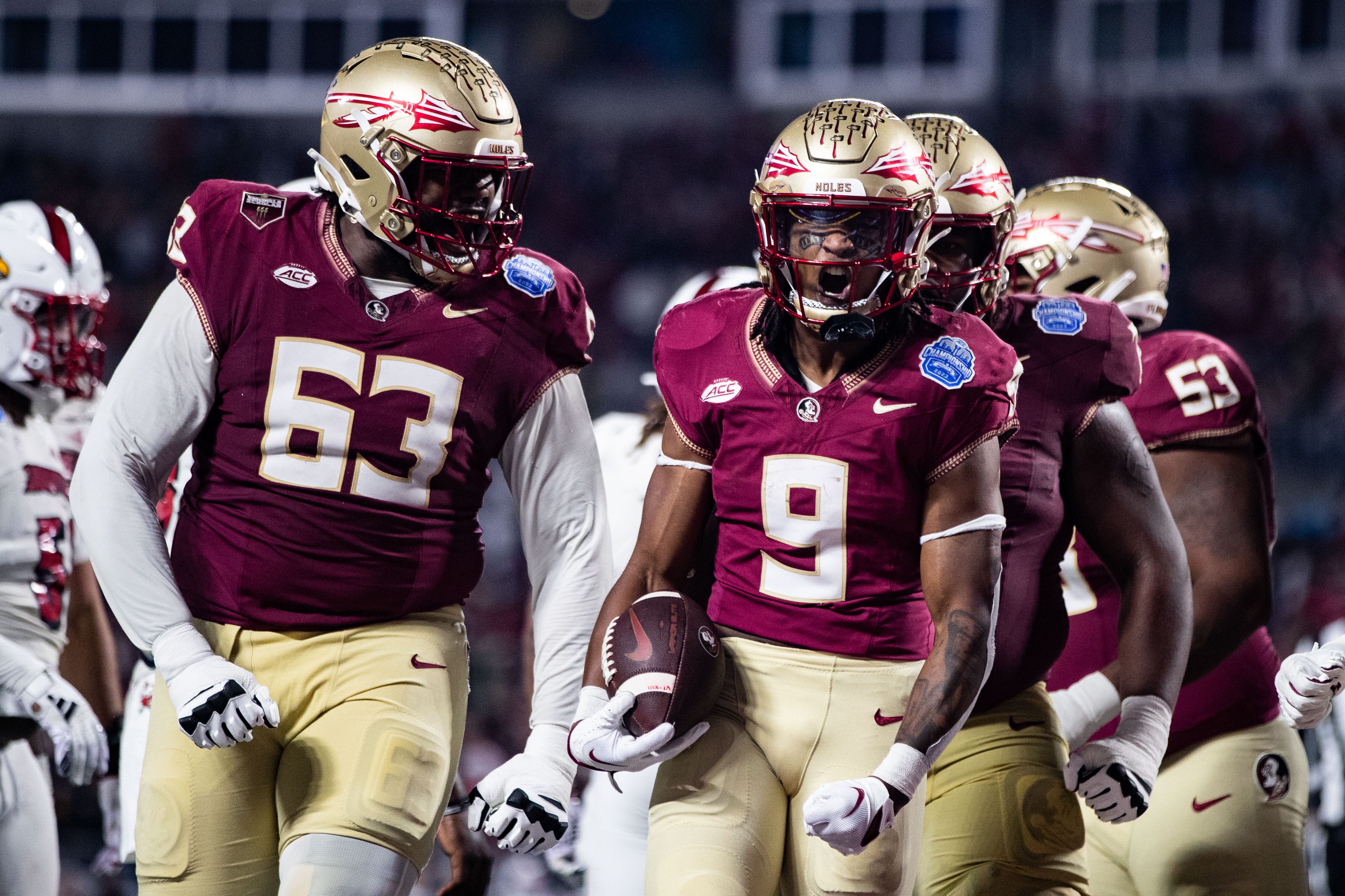 Lawrance Toafili holds the ball and yells to celebrates his touchdown