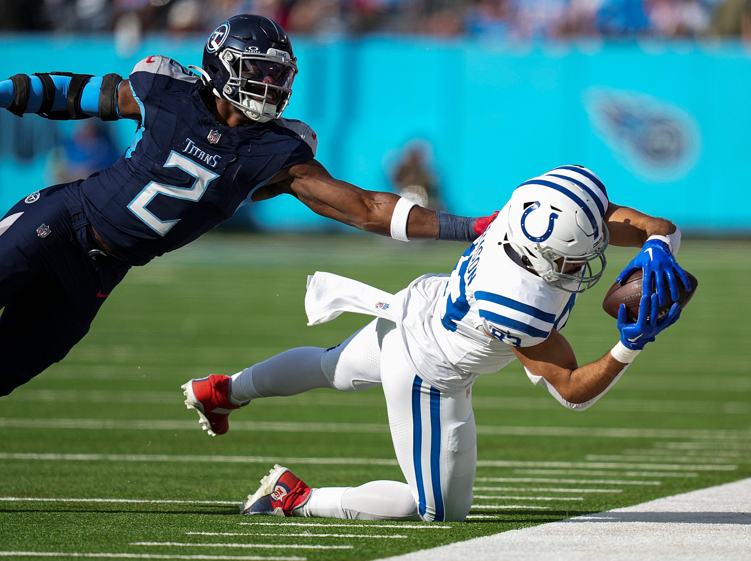 Indianapolis Colts tight end Kylen Granson (83) dives for a reception, under defensive pressure from Tennessee Titans linebacker Azeez Al-Shaair (2), on Sunday, Dec. 3, 2023, at Nissan Stadium in Nashville, Tenn.  