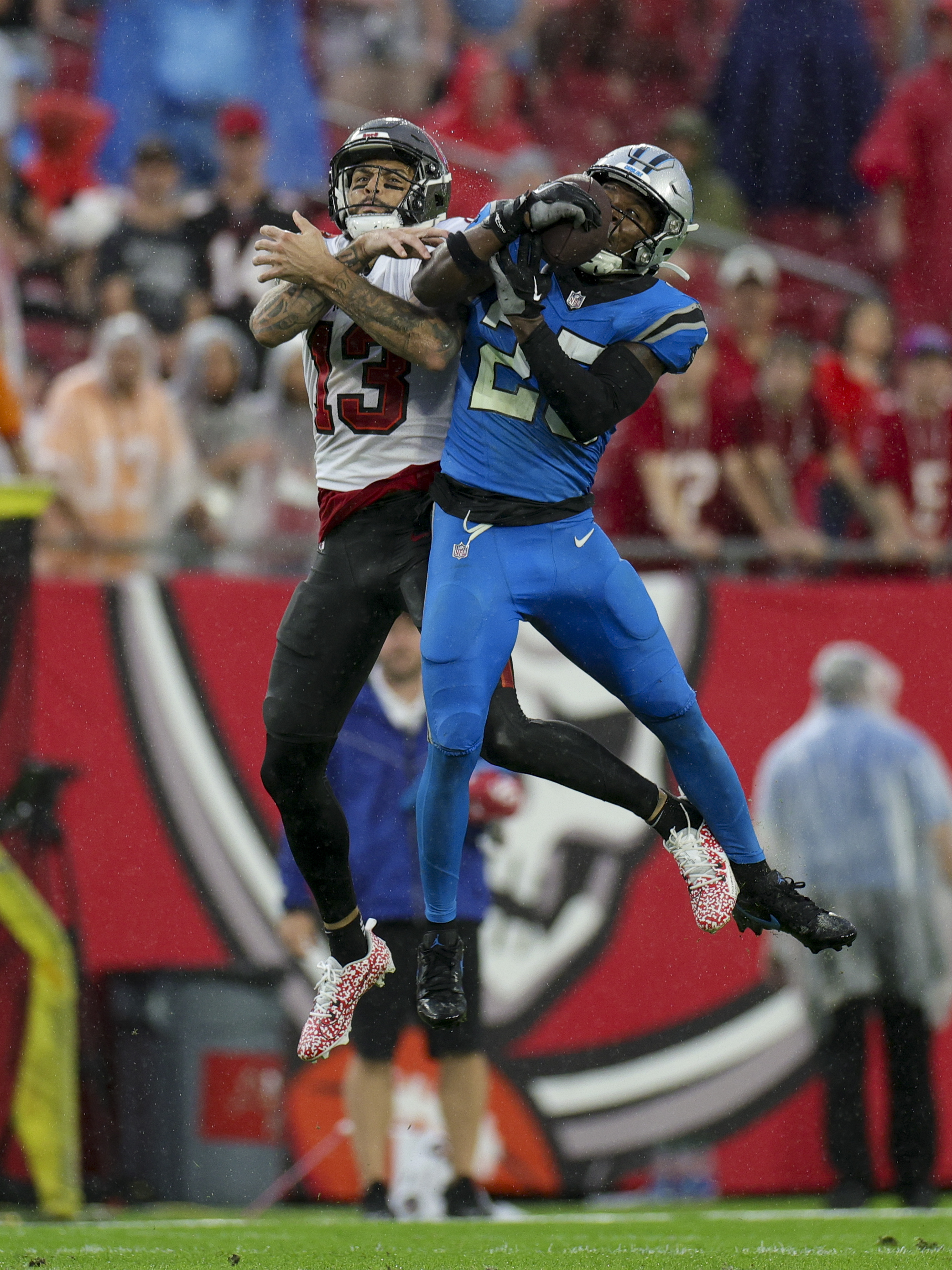 Dec 3, 2023; Tampa, Florida, USA; Carolina Panthers safety Xavier Woods (25) intercepts the ball from Tampa Bay Buccaneers wide receiver Mike Evans (13) in the second quarter at Raymond James Stadium. Mandatory Credit: Nathan Ray Seebeck-USA TODAY Sports