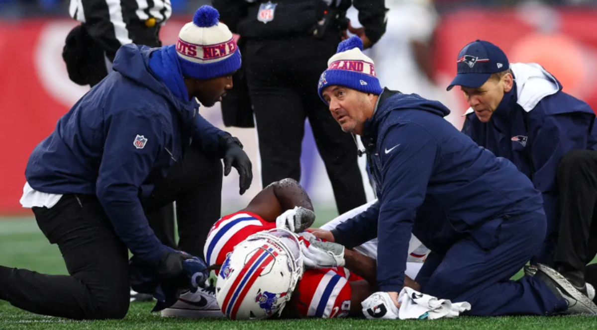 Trainers attend to Stevenson after his injury in Sunday's game.