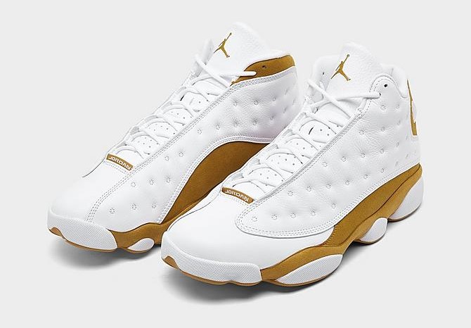 Side view of white and gold Air Jordan sneakers.