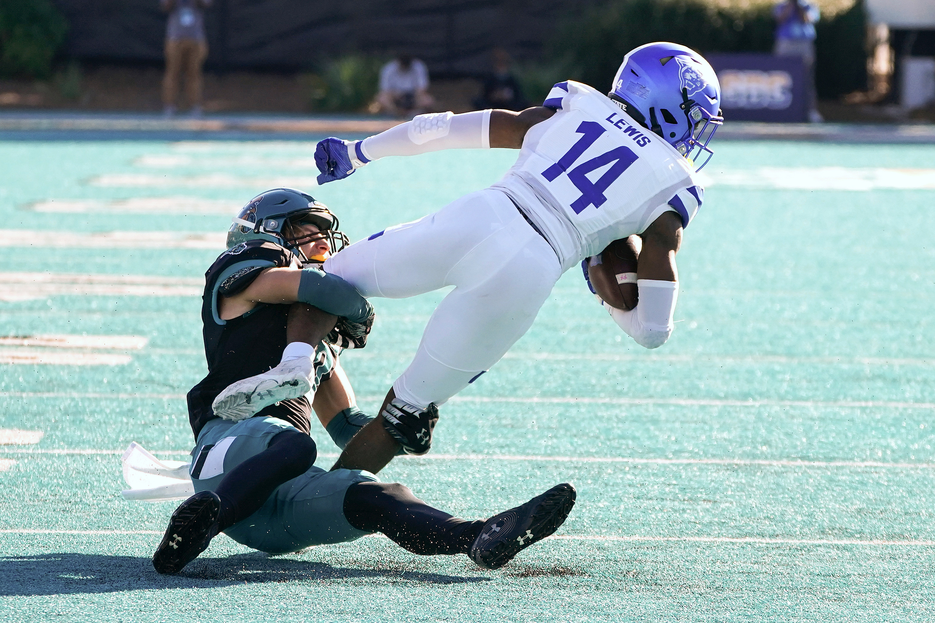 Nov 13, 2021; Conway, South Carolina, USA; Coastal Carolina Chanticleers cornerback Alex Spillum (10) tackles Georgia State Panthers Robert Lewis (14) at Brooks Stadium. Mandatory Credit: David Yeazell-USA TODAY Sports