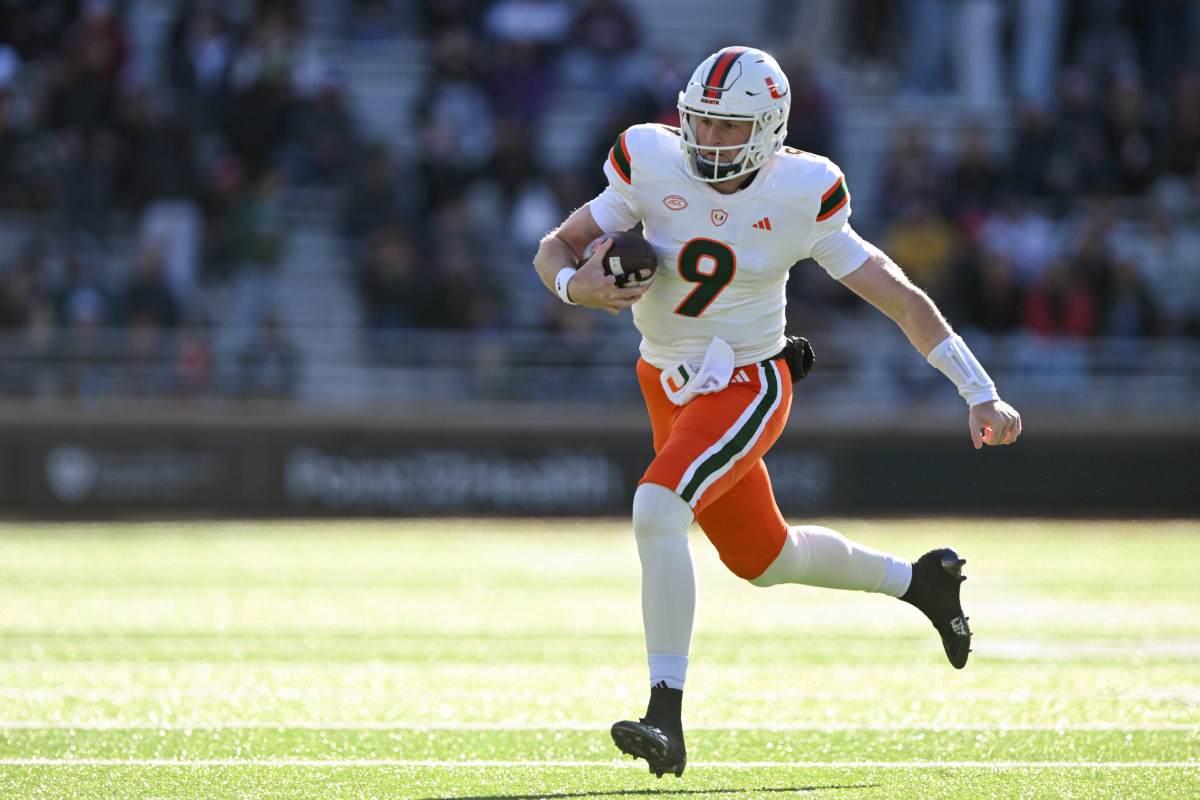 Nov 24, 2023; Chestnut Hill, Massachusetts, USA; Miami Hurricanes quarterback Tyler Van Dyke (9) runs against the Boston College Eaglesduring the first half at Alumni Stadium. Mandatory Credit: Brian Fluharty-USA TODAY Sports