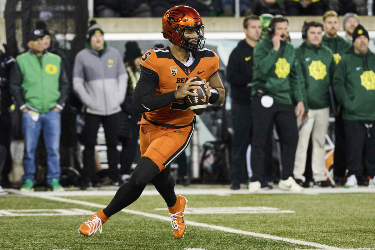 Nov 24, 2023; Eugene, Oregon, USA; Oregon State Beavers quarterback DJ Uiagalelei (5) rolls out to pass the ball during the first half against the Oregon Ducks at Autzen Stadium. Mandatory Credit: Troy Wayrynen-USA TODAY Sports