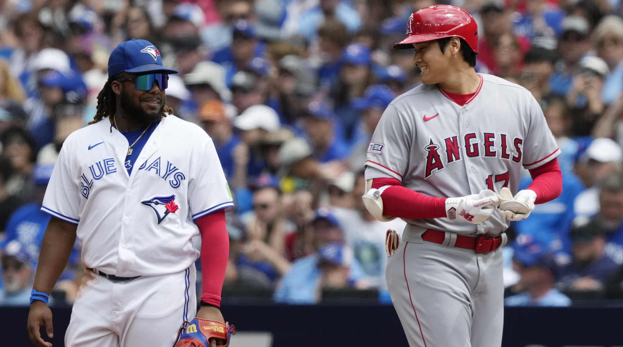 Angels designated hitter Shohei Ohtani (right) talks to Blue Jays first baseman Vladimir Guerrero Jr.