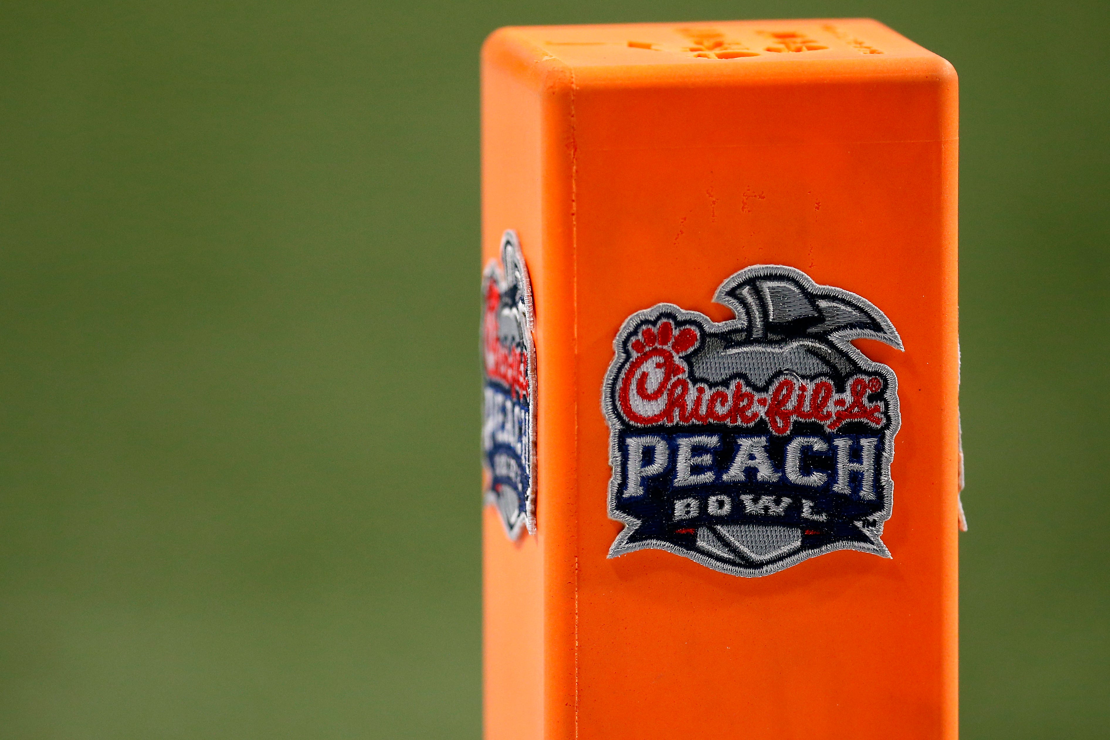 Pylons carry the Peach Bowl logo in the end zone during the third quarter of the Chick-fil-a Peach Bowl at Mercedes-Benz Stadium in Atlanta on Friday, Jan. 1, 2021. A last-minute field goal sealed a 24-21 win for the Bulldogs, leaving the Bearcats 9-1 on the season. Cincinnati Bearcats Vs Georgia Bulldogs Peach Bowl