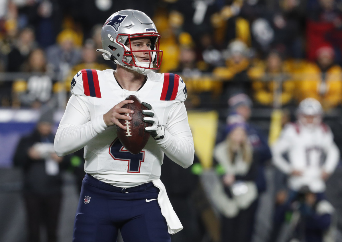 New England Patriots quarterback Bailey Zappe (4) looks to pass against the Pittsburgh Steelers during the first quarter at Acrisure Stadium.