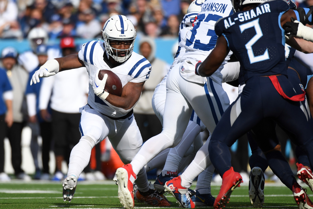 Dec 3, 2023; Nashville, Tennessee, USA; Indianapolis Colts running back Zack Moss (21) is stopped at the line during the first half against the Tennessee Titans at Nissan Stadium.