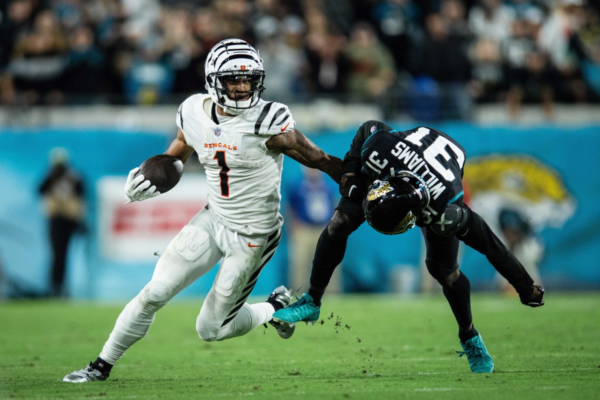 Dec 4, 2023; Jacksonville, Florida, USA; Cincinnati Bengals wide receiver Ja'Marr Chase (1) runs the ball against Jacksonville Jaguars cornerback Darious Williams (31) in extra time at EverBank Stadium.