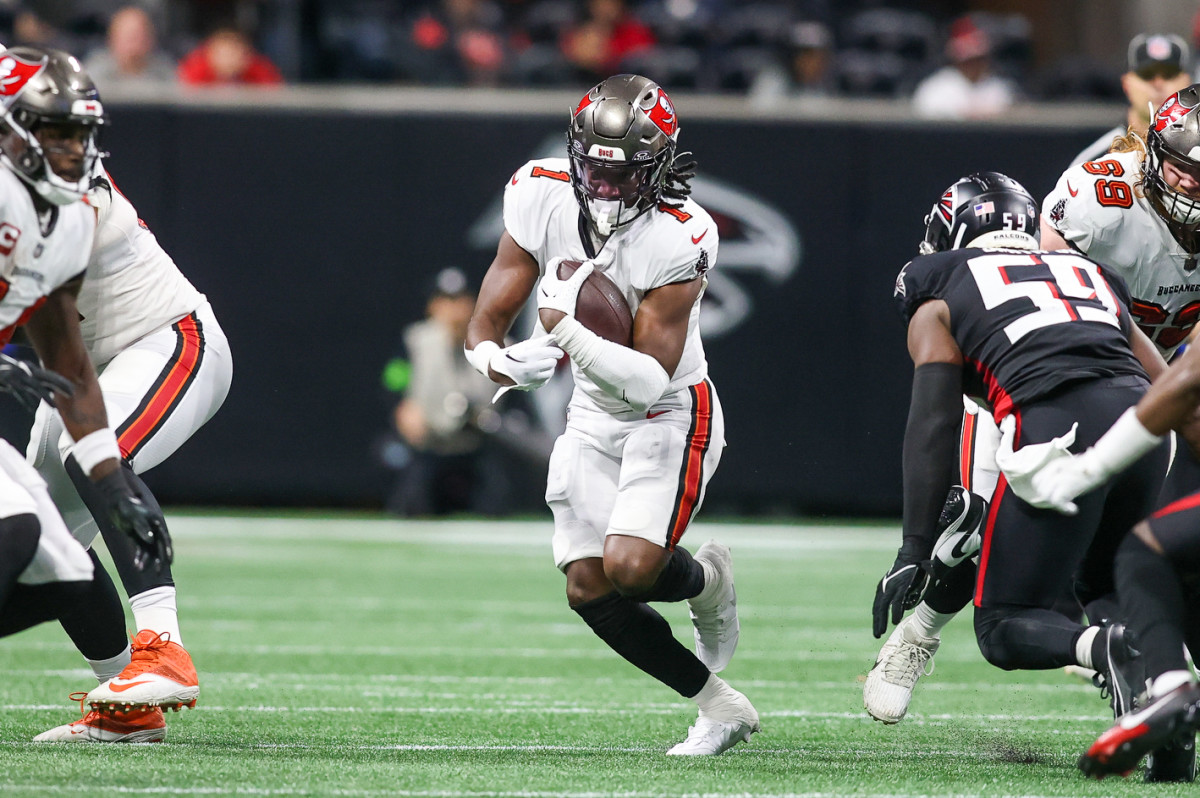 Dec 10, 2023; Atlanta, Georgia, USA; Tampa Bay Buccaneers running back Rachaad White (1) runs the ball against the Atlanta Falcons in the first half at Mercedes-Benz Stadium. Mandatory Credit: Brett Davis-USA TODAY Sports