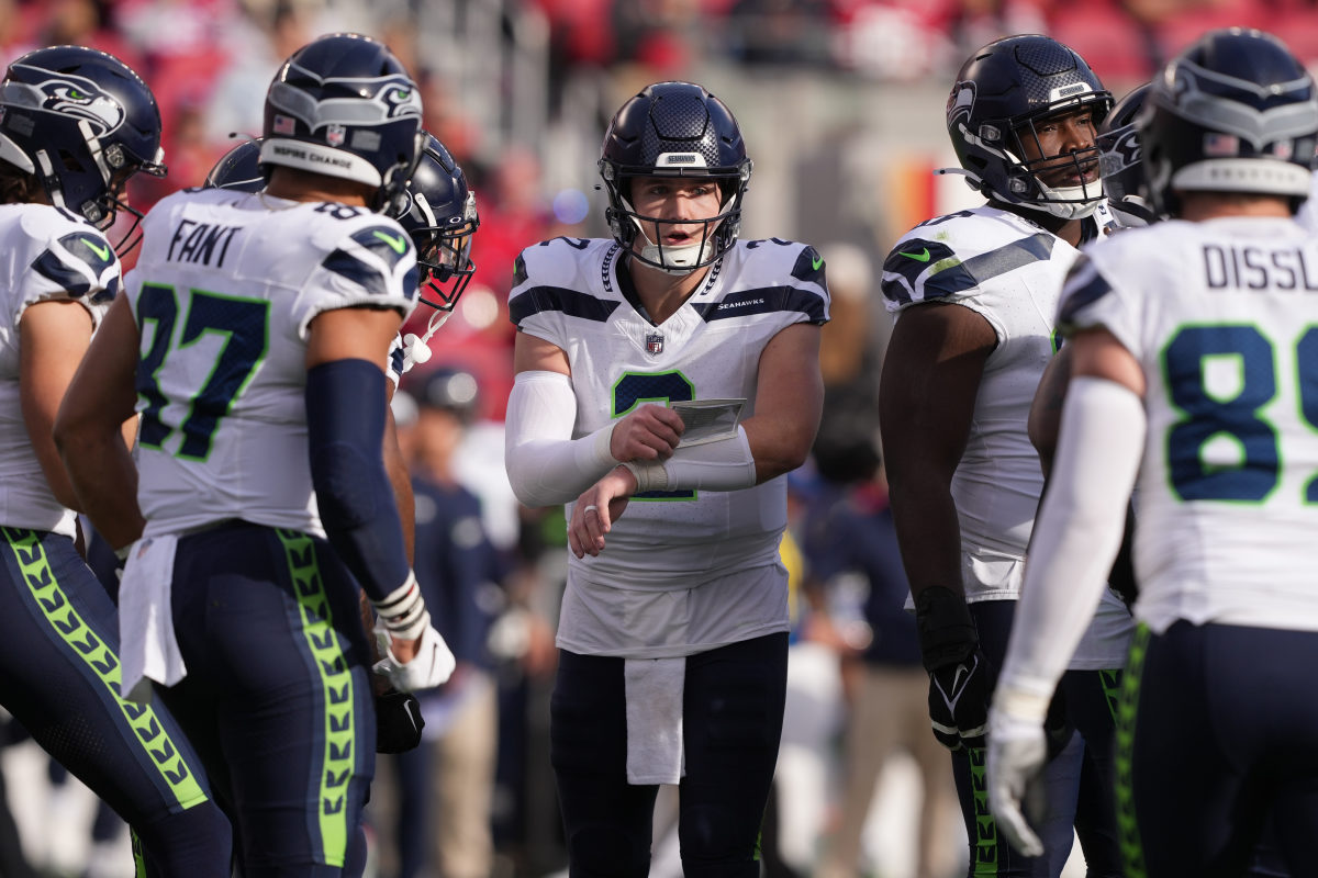 Lock leads the huddle during Sunday's game.