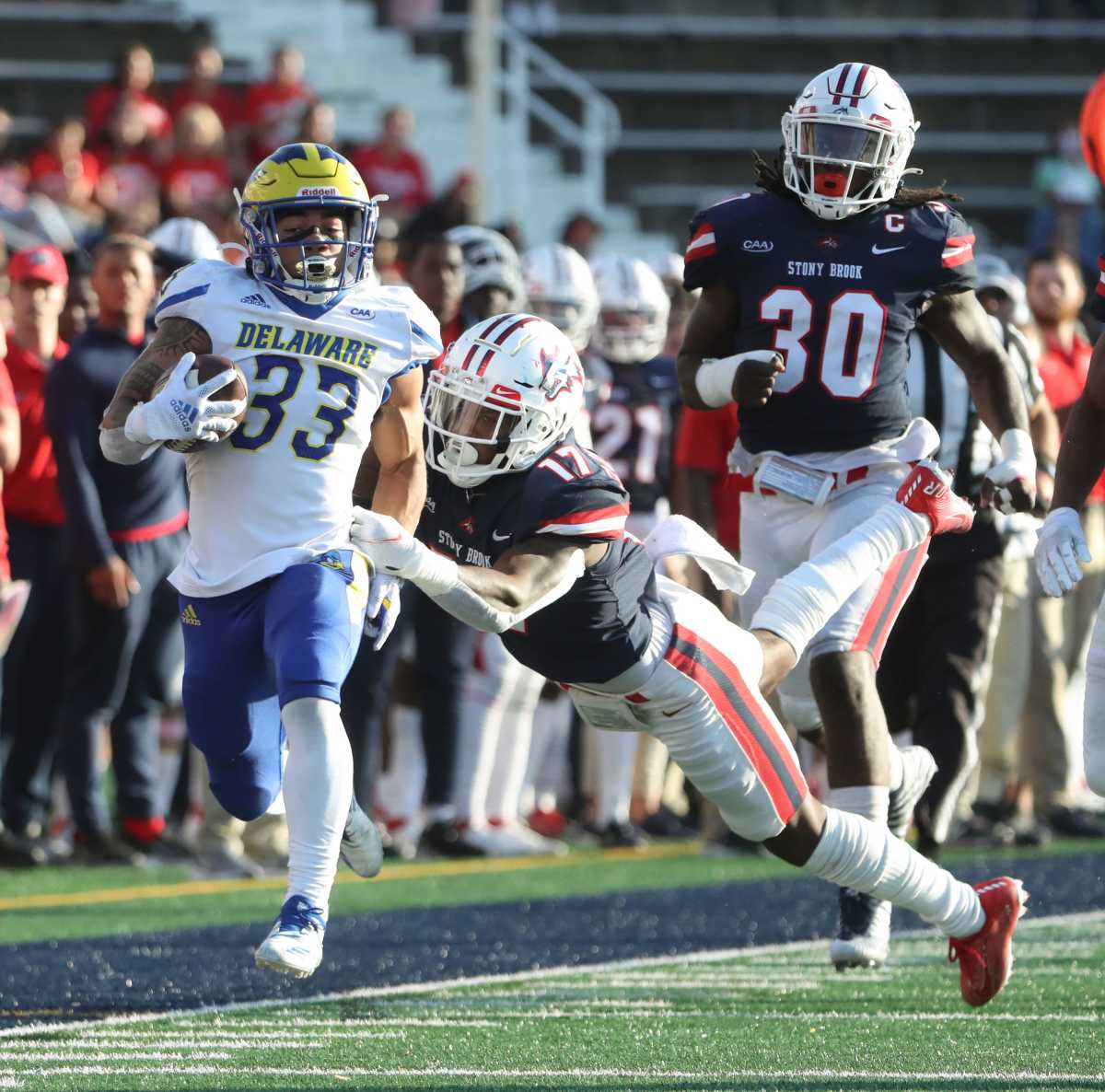 Delaware running back Dejoun Lee is dragged down by Stony Brook's Carthell Flowers-Lloyd at the end of a long run in the second quarter at Stony Brook, Saturday, Oct. 16, 2021. Ud V Stony Brook