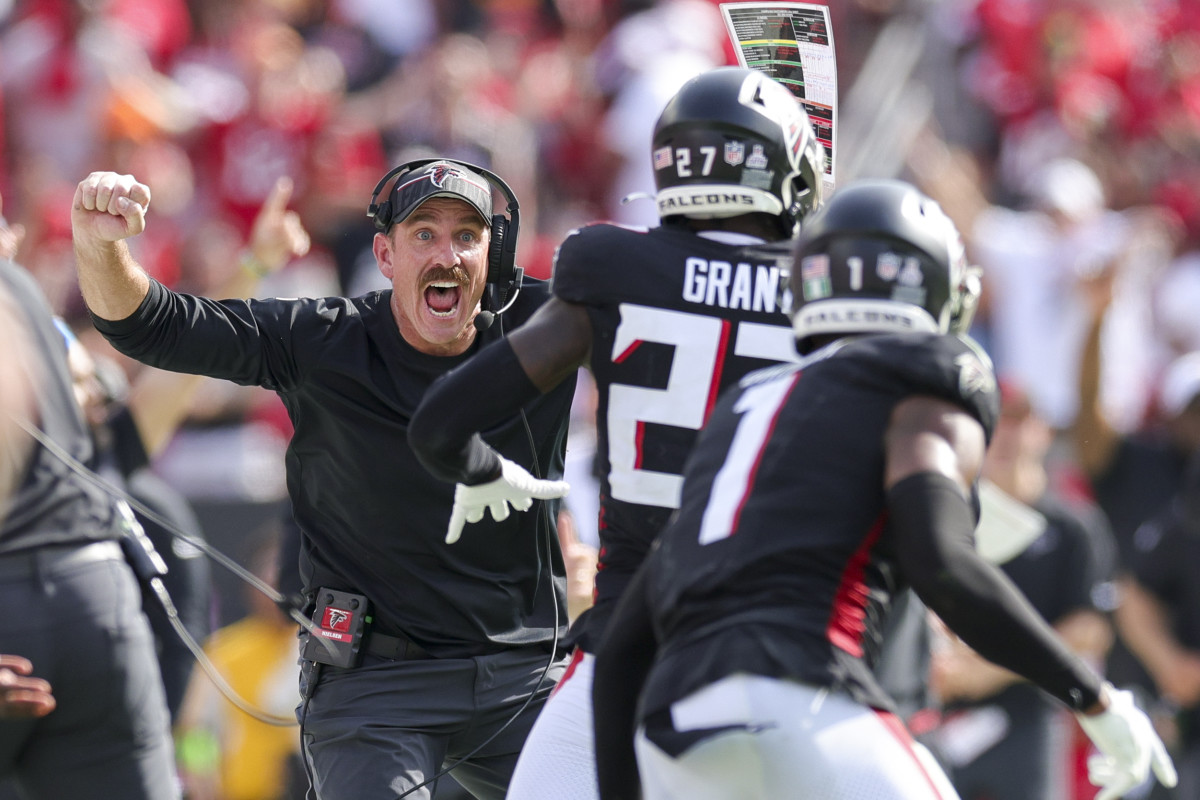 Atlanta Falcons defensive coordinator Ryan Nielsen reacts with safety Richie Grant (27) after intercepting the ball against the Tampa Bay Buccaneers in the fourth quarter at Raymond James Stadium.