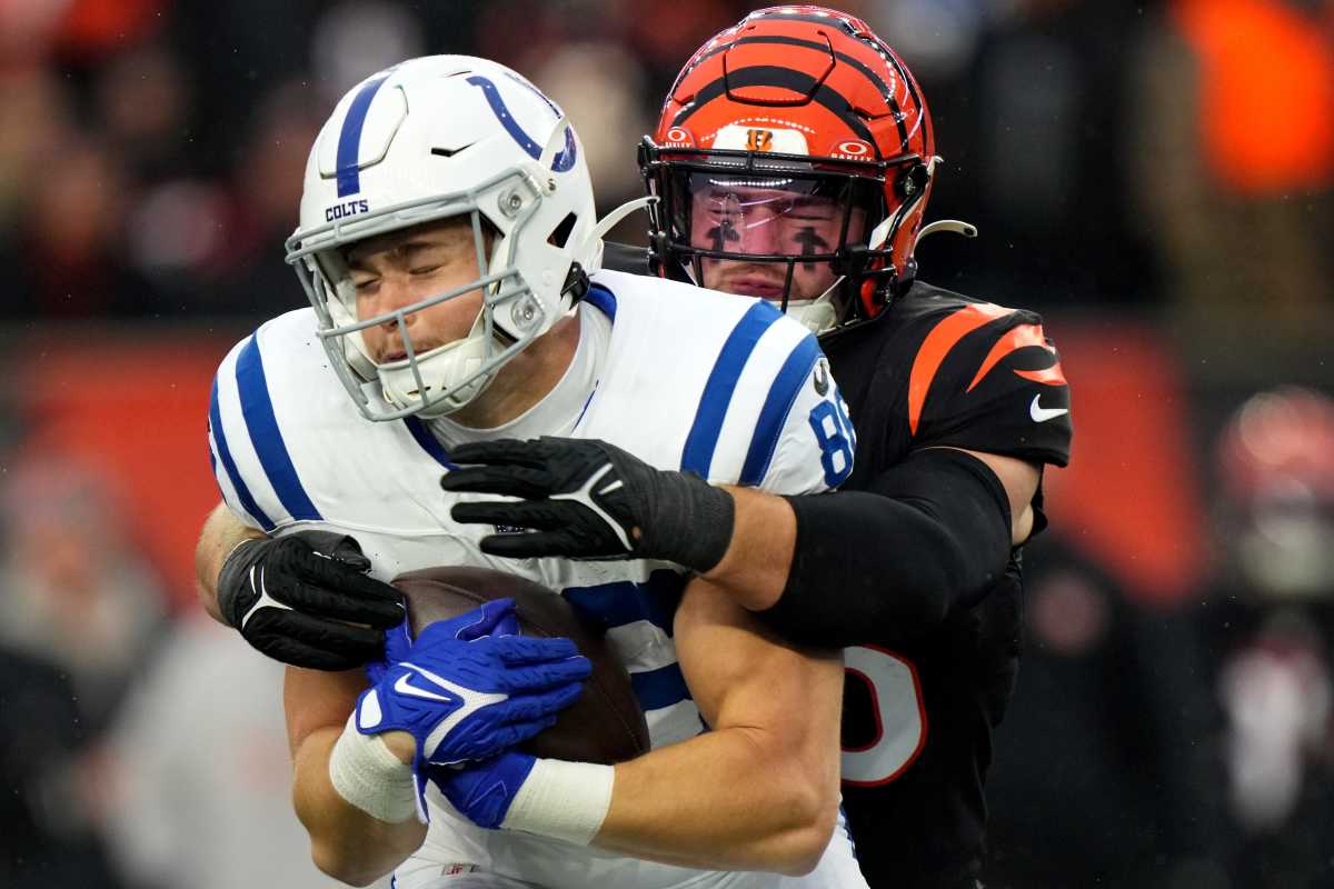 Cincinnati Bengals linebacker Logan Wilson (55) tackles Indianapolis Colts tight end Will Mallory (86) in the fourth quarter during a Week 14 NFL game between the Indianapolis Colts and the Cincinnati Bengals, Sunday, Dec. 10, 2023, at Paycor Stadium in Cincinnati.