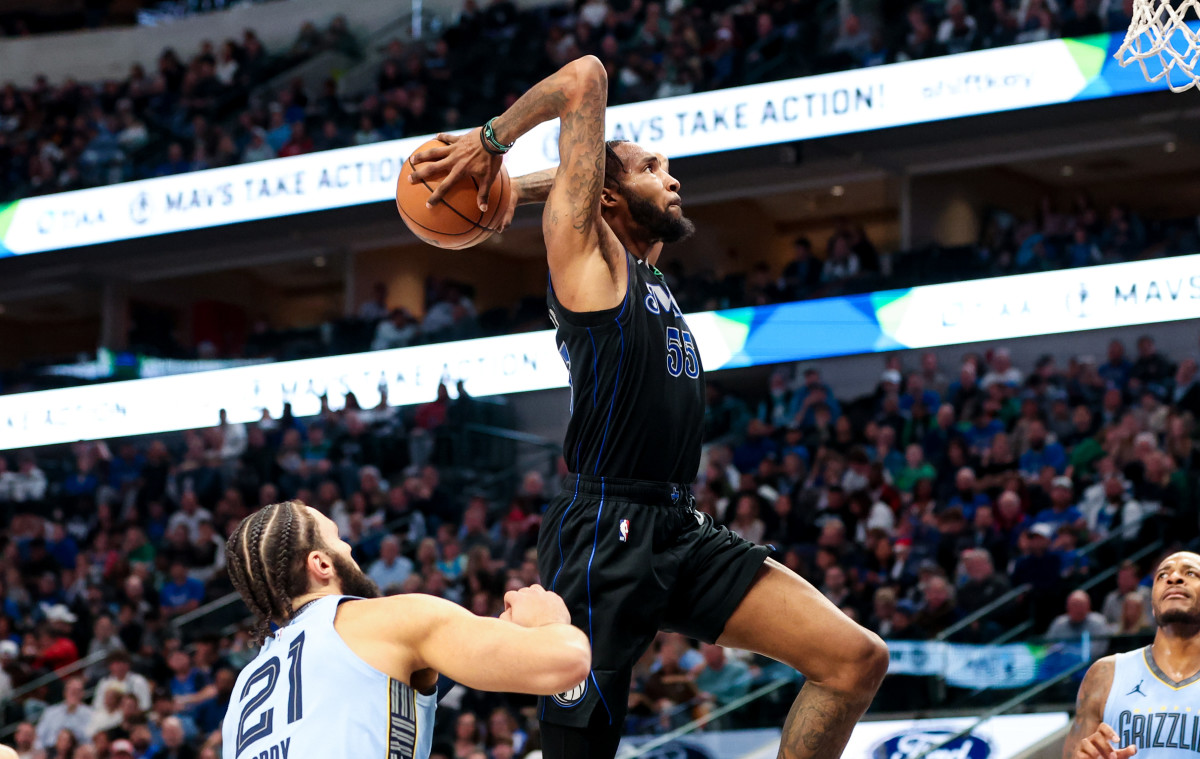 Mavs' Derrick Jones Jr. goes up for a two-handed dunk against the Memphis Grizzlies.