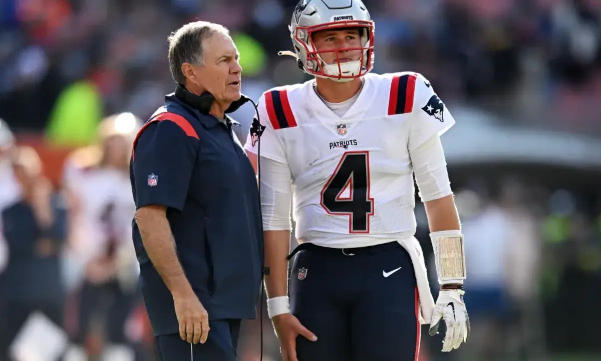 New England Patriots Bill Belichick speaks with quarterback Bailey Zappe