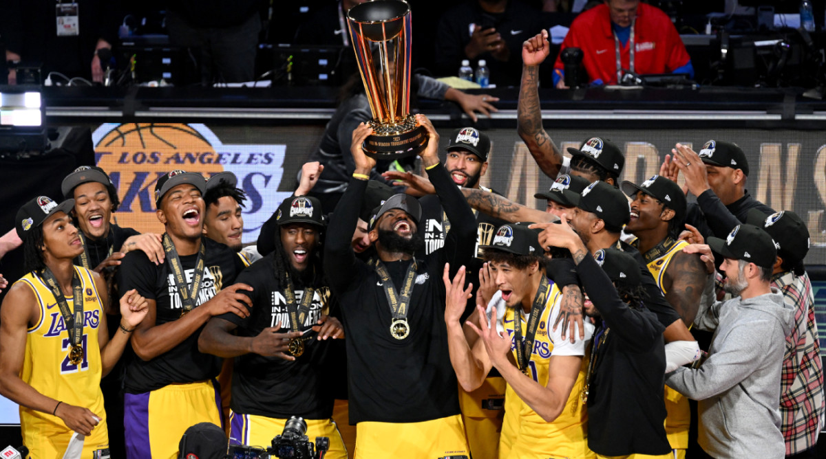 Dec 9, 2023; Las Vegas, Nevada, USA; Los Angeles Lakers forward LeBron James (23) hoists the NBA Cup and celebrates with teammates after winning the NBA In-Season Tournament Championship game against the Indiana Pacers at T-Mobile Arena. Mandatory Credit: Candice Ward-USA TODAY Sports  