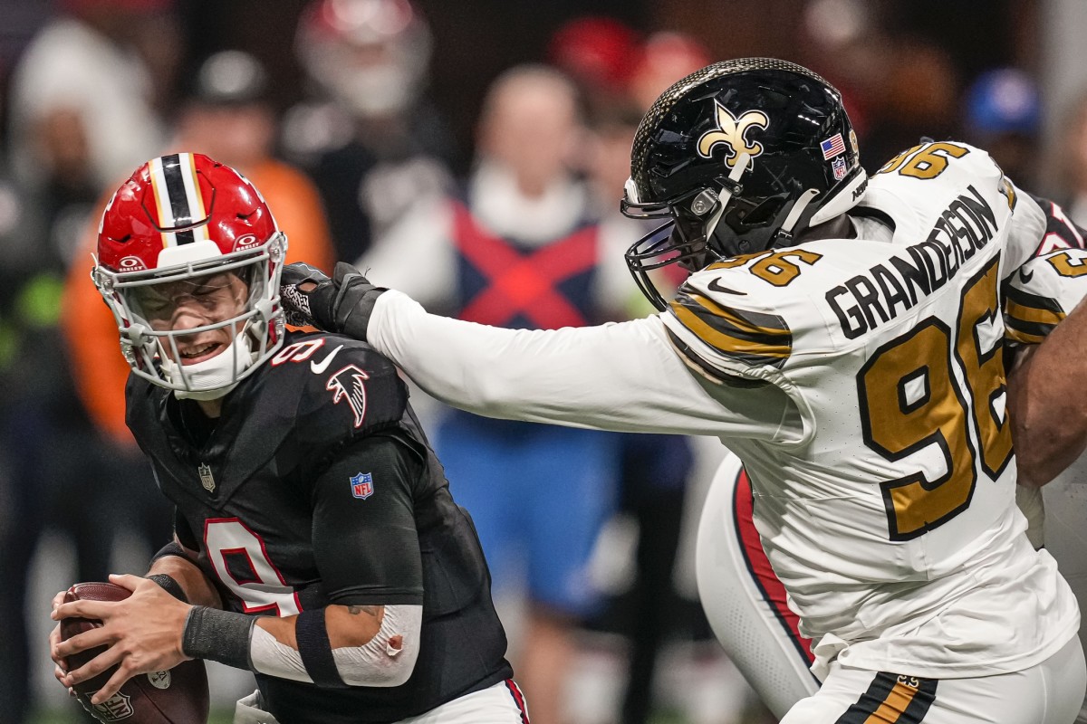 Atlanta Falcons quarterback Desmond Ridder (9) takes a hit from New Orleans Saints defensive end Carl Granderson (96). Mandatory Credit: Dale Zanine-USA TODAY Sports