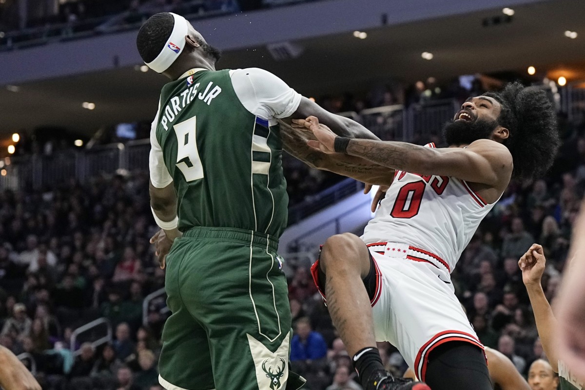 Chicago Bulls guard Coby White (0) is fouled by Milwaukee Bucks forward Bobby Portis (9) 