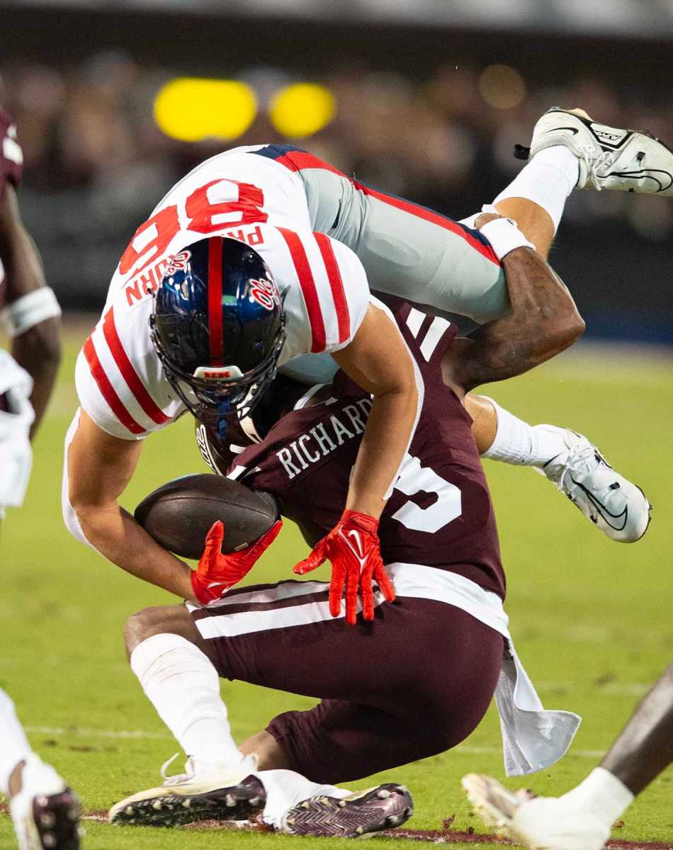 Mississippi State cornerback Decamerion Richardson tackles Ole Miss tight end Caden Prieskorn.