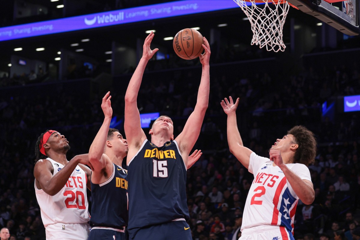 Denver Nuggets center Nikola Jokic (15) rebounds against Brooklyn Nets forward Cameron Johnson (2) and center Day'Ron Sharpe (20) 