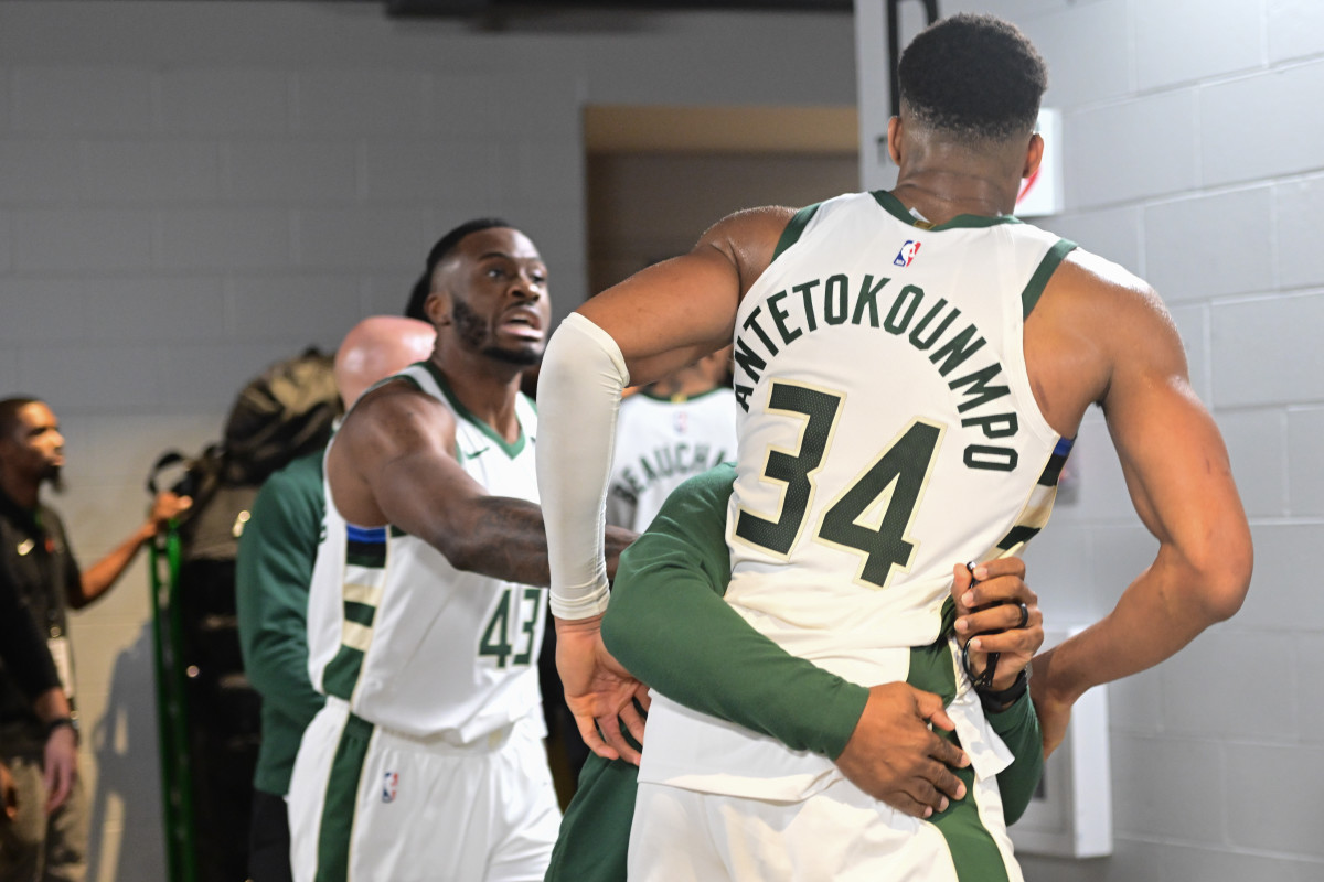 Milwaukee Bucks forward Giannis Antetokounmpo is restrained by a coach outside the Indiana Pacers locker room after the game at Fiserv Forum.