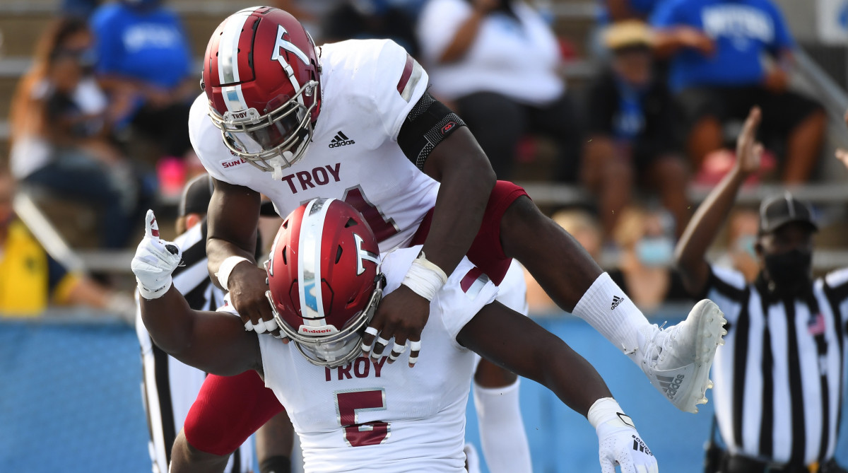 Troy defensive tackle Will Choloh (bottom) and linebacker Javon Solomon (top) celebrate after a safety.