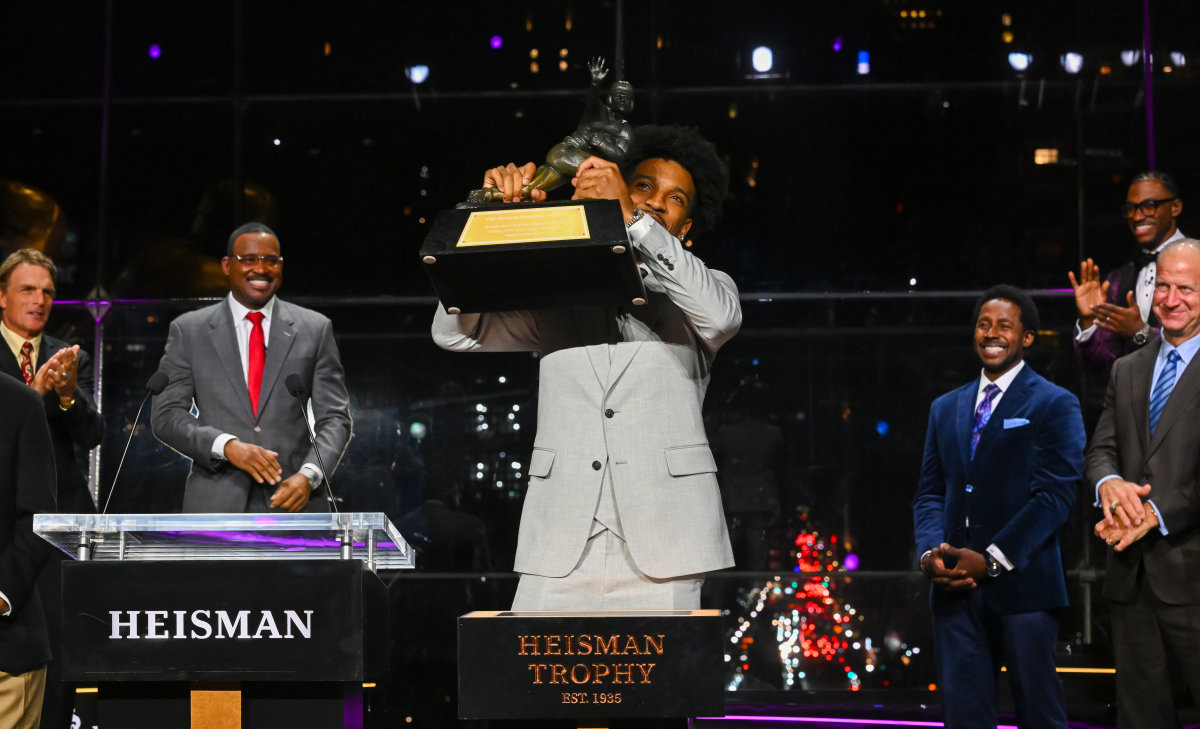 Dec 9, 2023; New York, New York, USA; Jayden Daniels holds up the Heisman Trophy after winning the Heisman Trophy in the Astor ballroom at the New York Marriott Marquis.