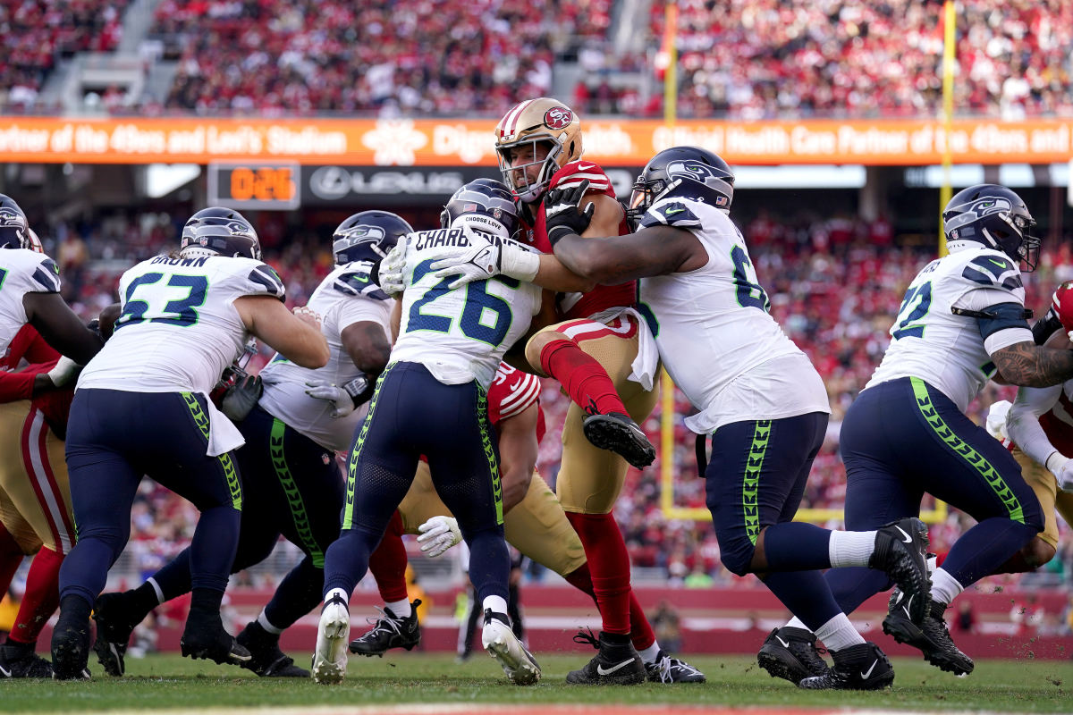 San Francisco 49ers defensive end Nick Bosa (97) tackles Seattle Seahawks running back Zach Charbonnet (26) near the end zone in the second quarter at Levi's Stadium.