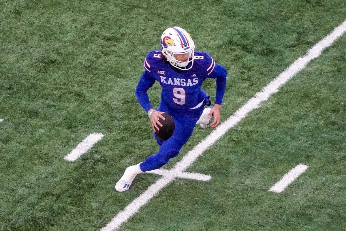 Kansas Jayhawks quarterback Jason Bean runs the ball