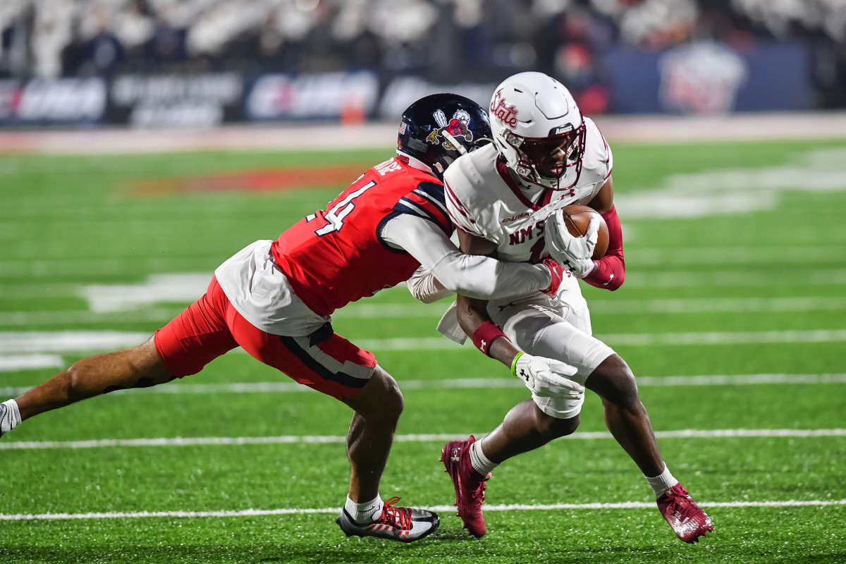 Dec 1, 2023; Lynchburg, VA, USA; Liberty Flames defensive back Preston Hodge (24) tackles New Mexico State Aggies wide receiver Kordell David (11) after a catch during the third quarter at Williams Stadium