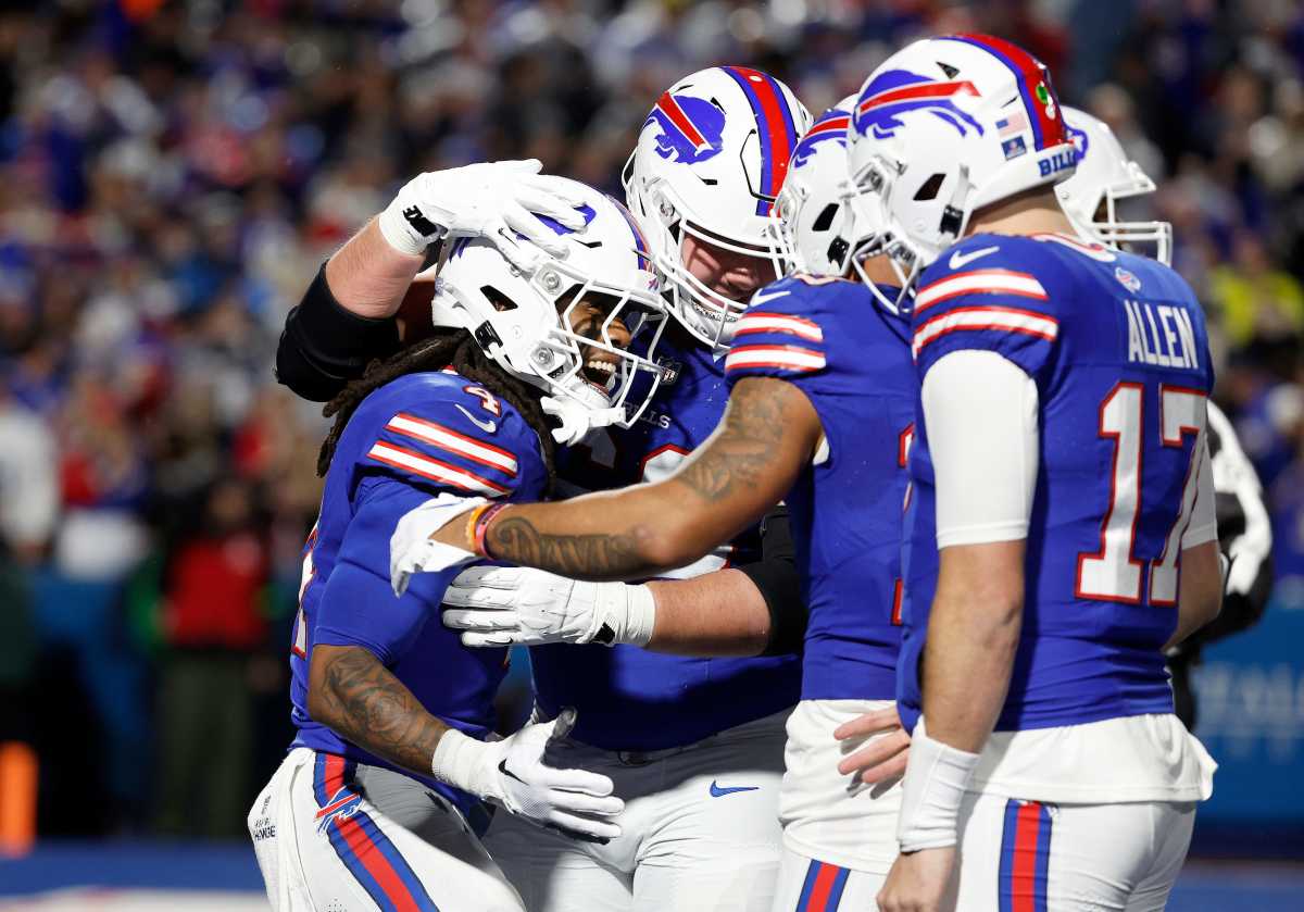 The Buffalo Bills offense celebrating after a James Cook touchdown.