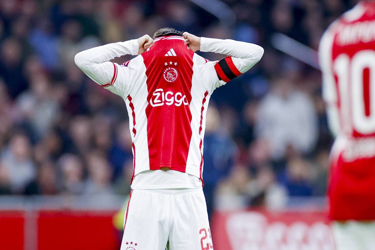 Steven Berghuis pictured covering his face with his Ajax jersey after producing a shocking miss against PEC Zwolle during an Eredivisie game in December 2023