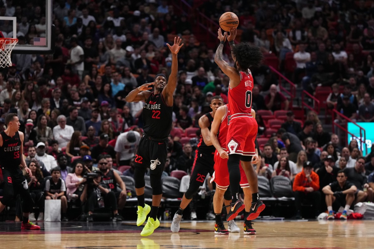 Chicago Bulls guard Coby White (0) puts up a shot over Miami Heat forward Jimmy Butler (22) during the second half at Kaseya Center.