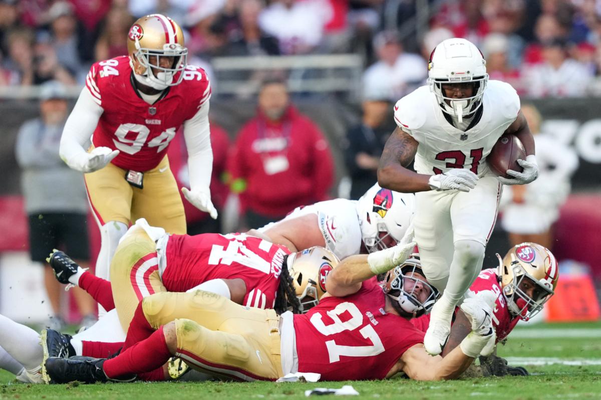 Arizona Cardinals running back Emari Demercado (31) runs by San Francisco 49ers defensive end Nick Bosa (97) during the first half at State Farm Stadium.