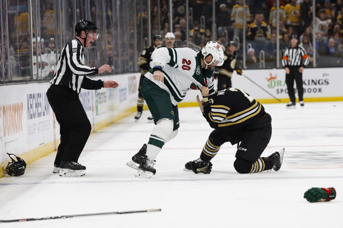 Dec 19, 2023; Boston, Massachusetts, USA; Minnesota Wild left wing Pat Maroon (20) takes down Boston Bruins defenseman Parker Wotherspoon (29) in a fight during the second period at TD Garden.