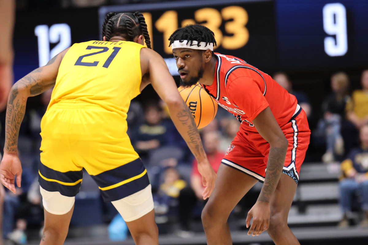 West Virginia guard RaeQuan Battle defends Radford guard Bryan Antoine in the first half at the WVU Coliseum.