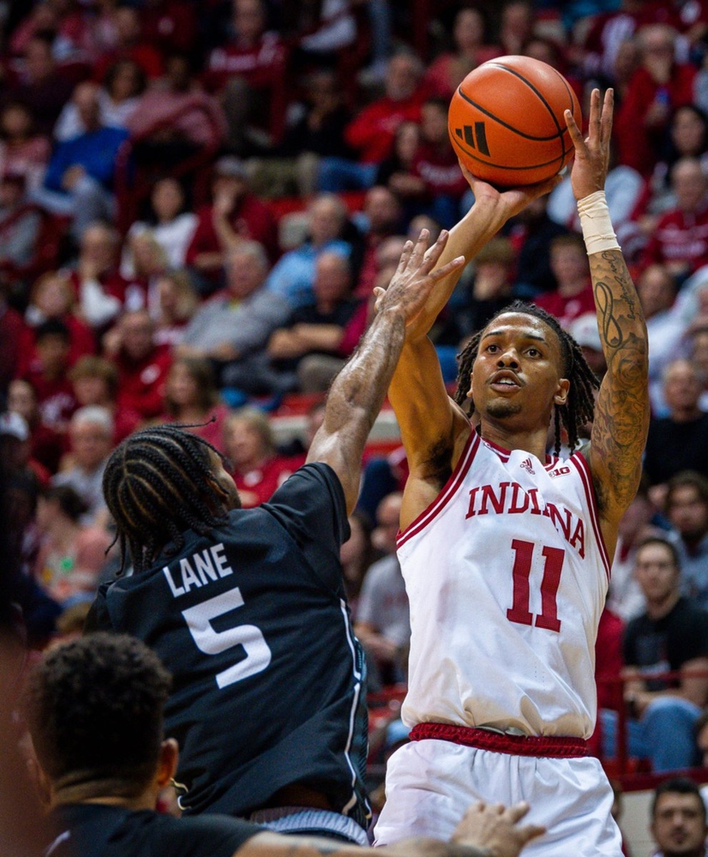 Indiana's CJ Gunn (11) shoots over North Alabama's Jacari Lane (5) during the first half of the Indiana versus North Alabama men's basketball game at Simon Skjodt Assembly Hall on Thursday, December 21, 2023.
