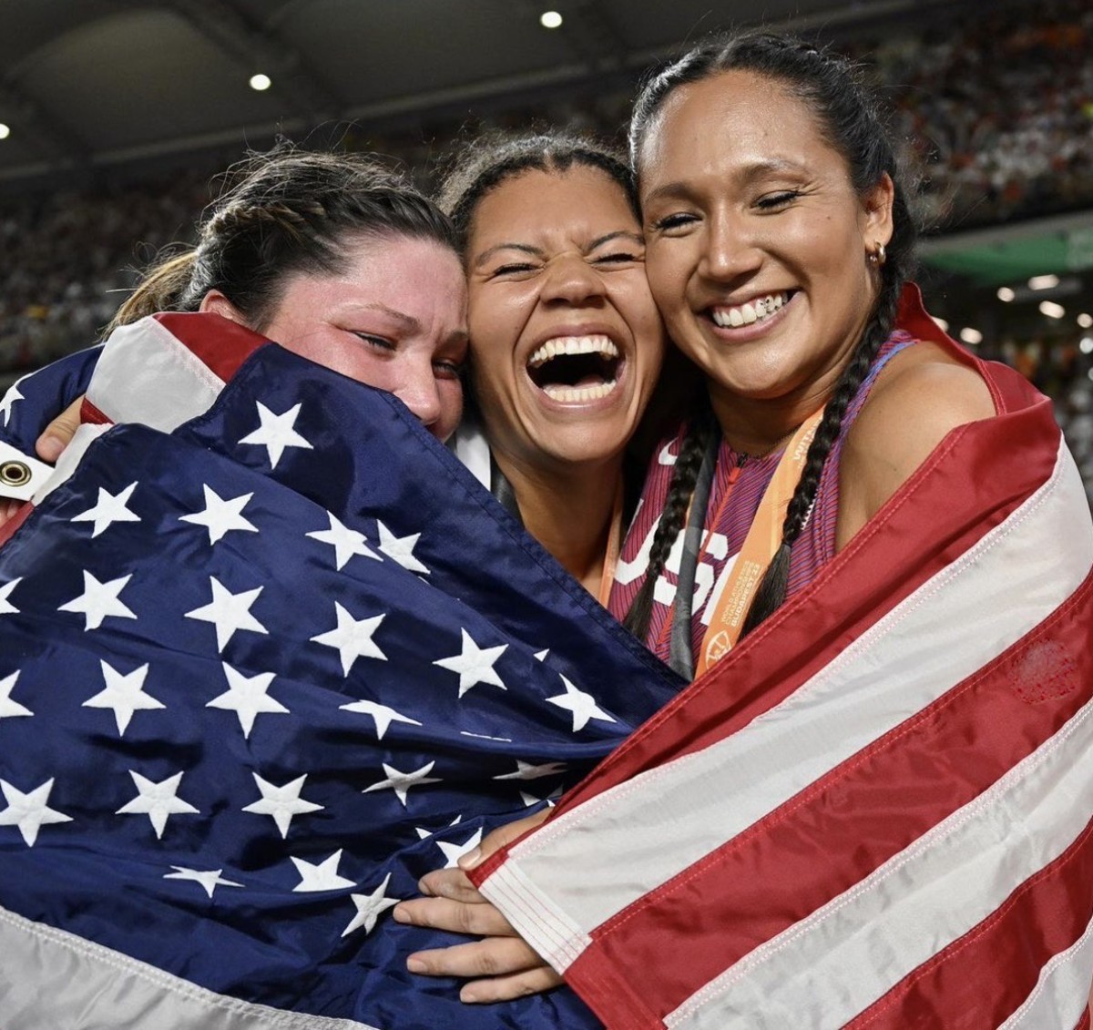 Camryn Rogers, center, celebrates with other medalists