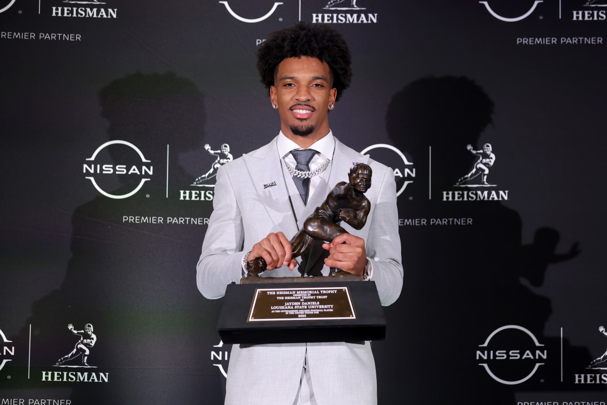 LSU QB Jayden Daniels posing with the 2023 Heisman Trophy (9th Dec., 2023)